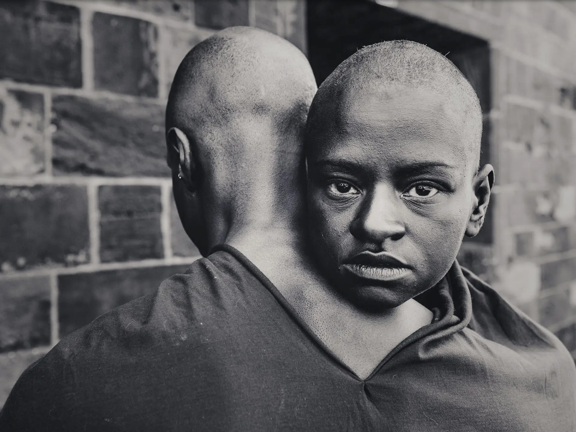 Black and white portrait of Mirelle Martins resting her head against Shamel Pitts in a scene from BLACK VELVET
