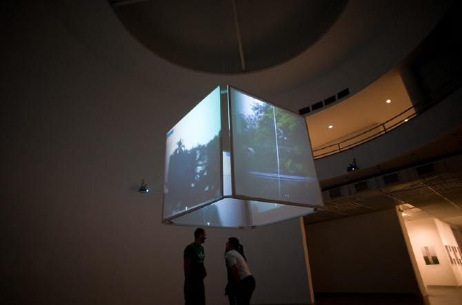 Video projection cube suspended inside the museum atrium