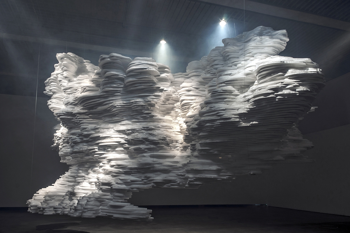 Paper landscape stretching through the gallery under diffuse light